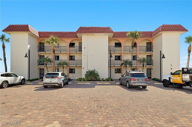 view of building exterior with uncovered parking