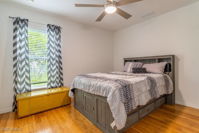 bedroom with ceiling fan and light hardwood / wood-style flooring