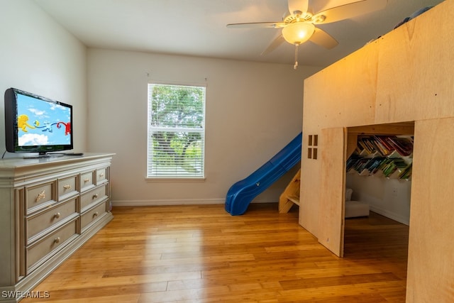 bedroom featuring light wood-type flooring, a closet, and ceiling fan