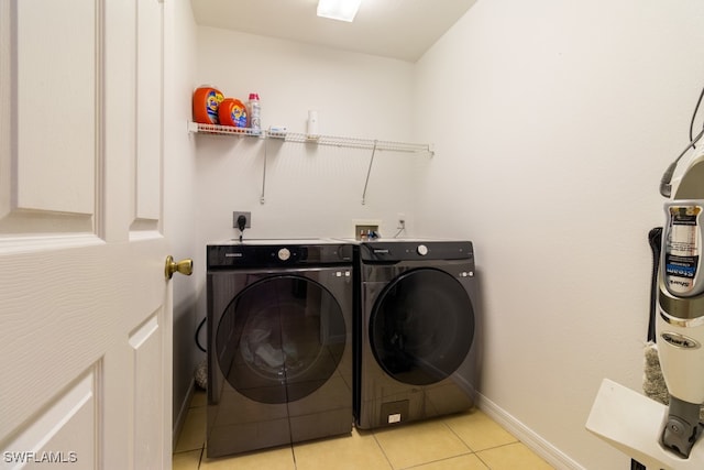 laundry room with light tile patterned floors and independent washer and dryer