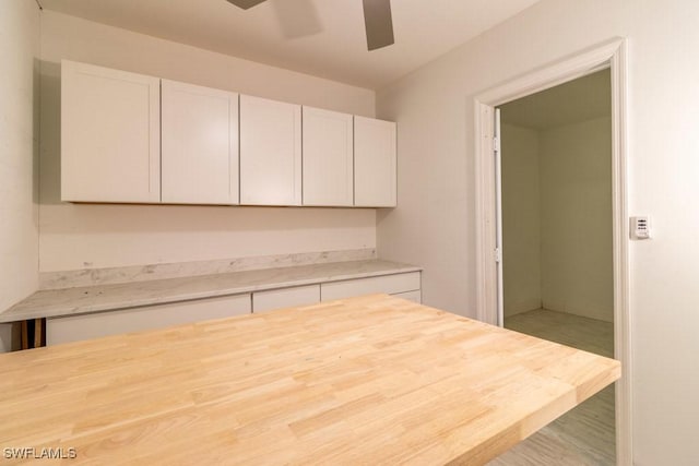 kitchen featuring ceiling fan, white cabinets, and light hardwood / wood-style floors