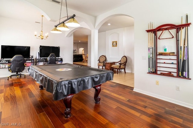 game room featuring hardwood / wood-style flooring, pool table, and an inviting chandelier