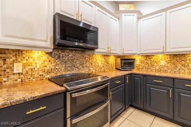 kitchen with white cabinets, stainless steel appliances, and tasteful backsplash