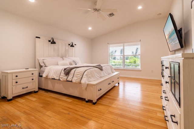 bedroom with vaulted ceiling, light hardwood / wood-style flooring, and ceiling fan