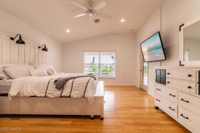 bedroom with ceiling fan, lofted ceiling, and light wood-type flooring