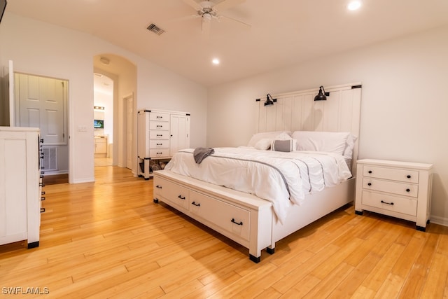 bedroom featuring ceiling fan, lofted ceiling, and light hardwood / wood-style flooring