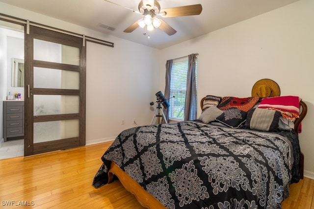 bedroom with ceiling fan and hardwood / wood-style floors