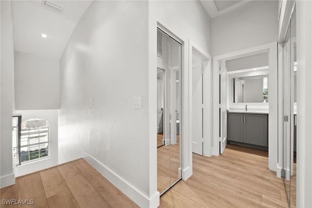 corridor with light hardwood / wood-style flooring