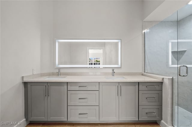 bathroom with vanity and a shower with door