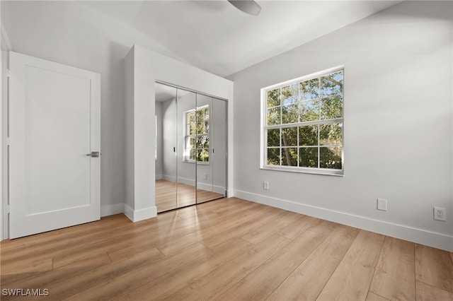 unfurnished bedroom with a closet and light hardwood / wood-style floors