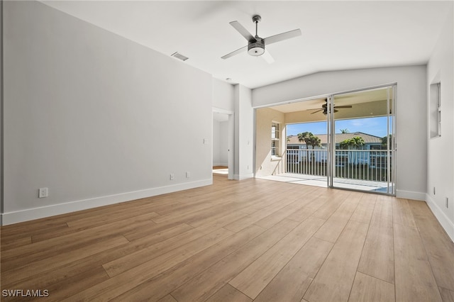 unfurnished living room with light wood-type flooring and vaulted ceiling