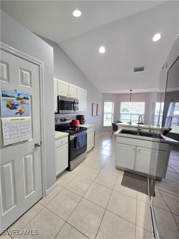 kitchen with sink, white cabinets, and appliances with stainless steel finishes