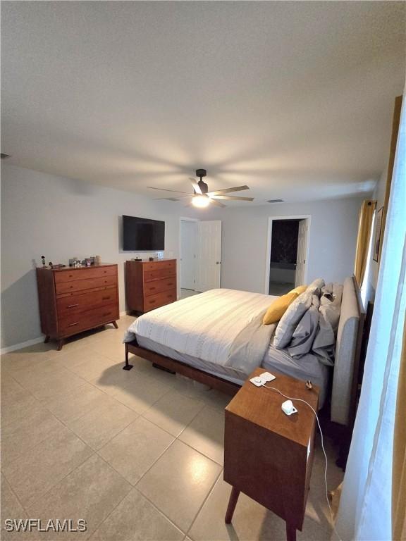 bedroom featuring ceiling fan and light tile patterned flooring