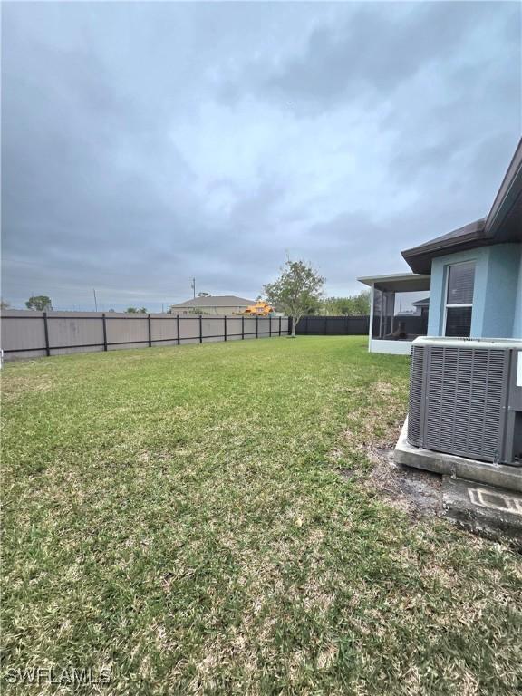 view of yard featuring a sunroom and cooling unit