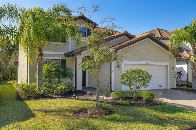 mediterranean / spanish home featuring a garage and a front yard