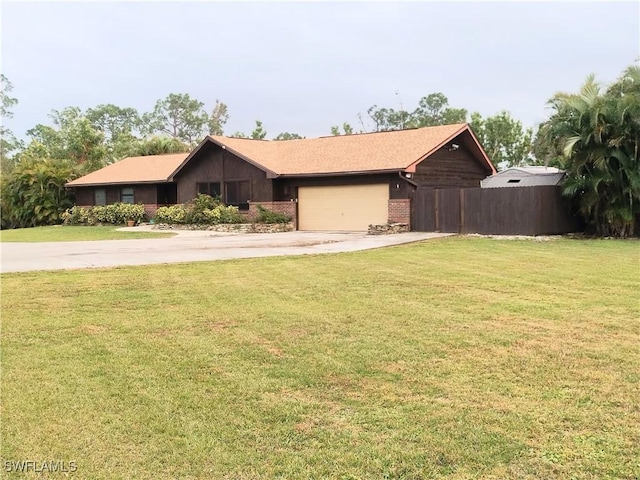 ranch-style house featuring a garage and a front lawn