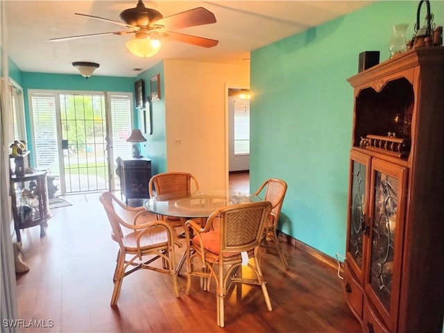 dining area featuring ceiling fan and wood-type flooring