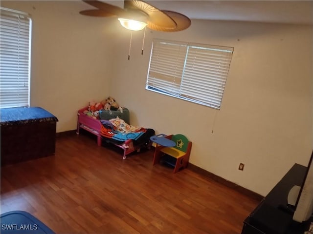 bedroom featuring ceiling fan and dark hardwood / wood-style flooring