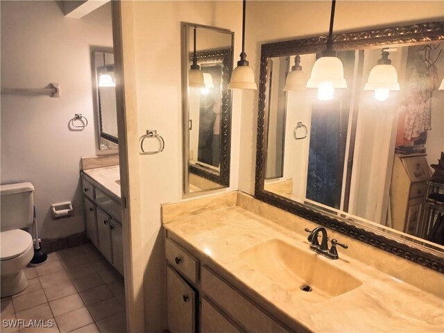 bathroom with tile patterned floors, vanity, and toilet