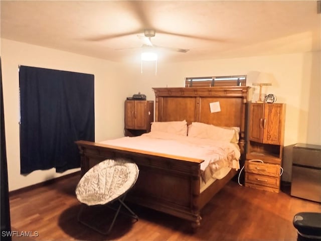 bedroom with ceiling fan and dark hardwood / wood-style floors