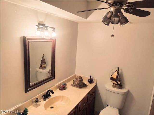 bathroom featuring ceiling fan, vanity, and toilet