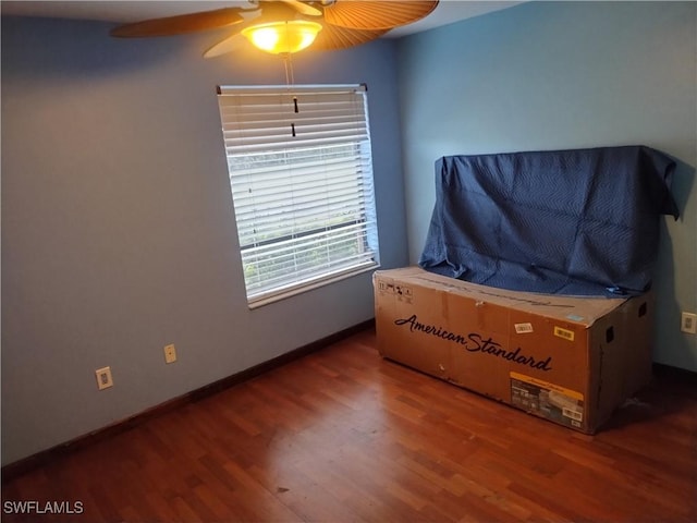 bedroom with ceiling fan and dark hardwood / wood-style floors