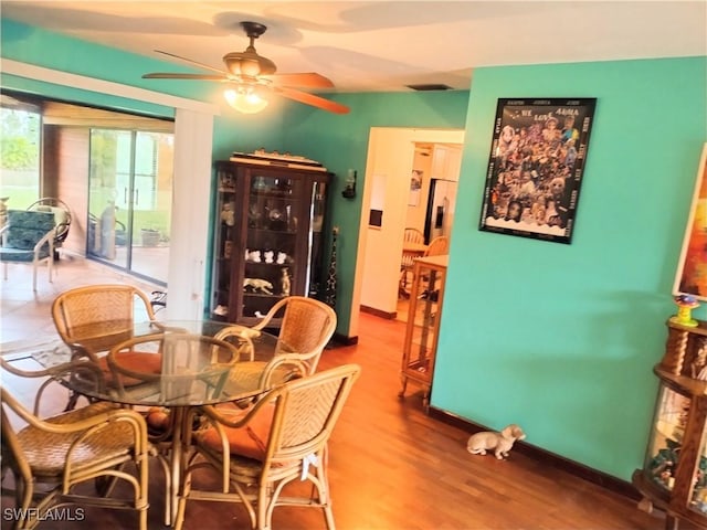 dining space with hardwood / wood-style flooring and ceiling fan