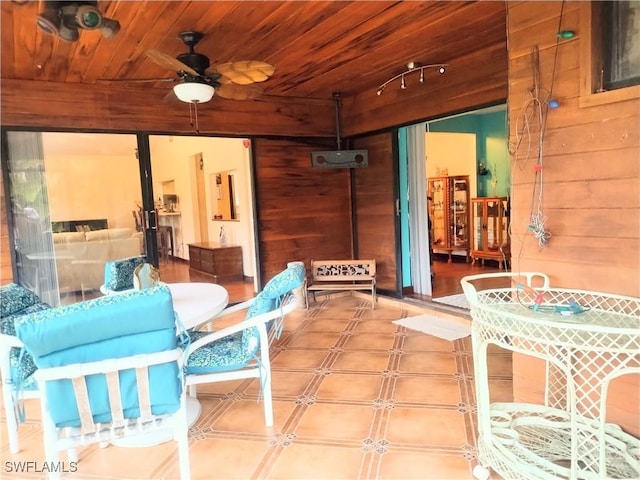 interior space featuring ceiling fan and wood ceiling