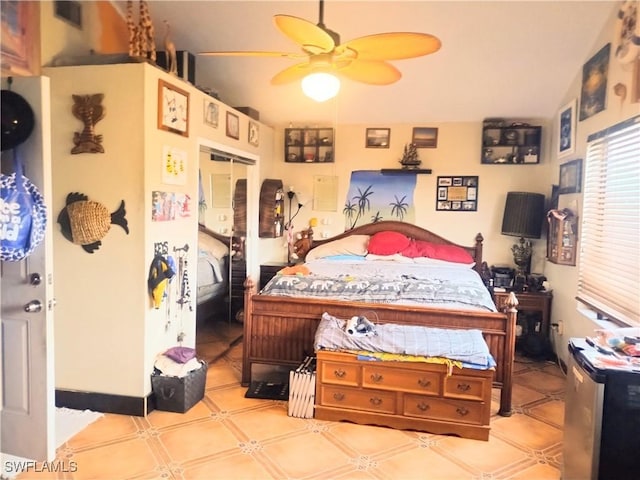 bedroom with ceiling fan and a closet