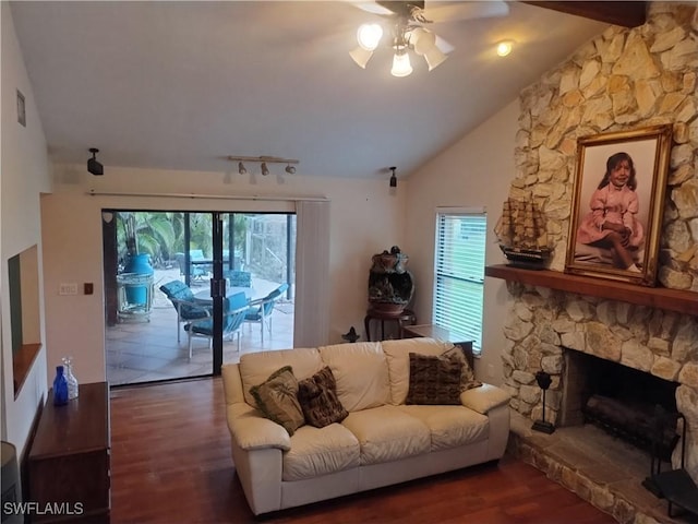 living room featuring a fireplace, ceiling fan, dark hardwood / wood-style flooring, and lofted ceiling