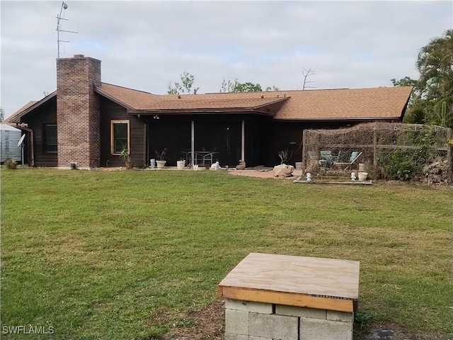 back of house with a lawn