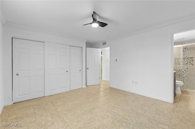 unfurnished bedroom with light tile patterned flooring, visible vents, a closet, ensuite bath, and crown molding