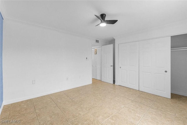 unfurnished bedroom featuring visible vents, a closet, ornamental molding, and baseboards