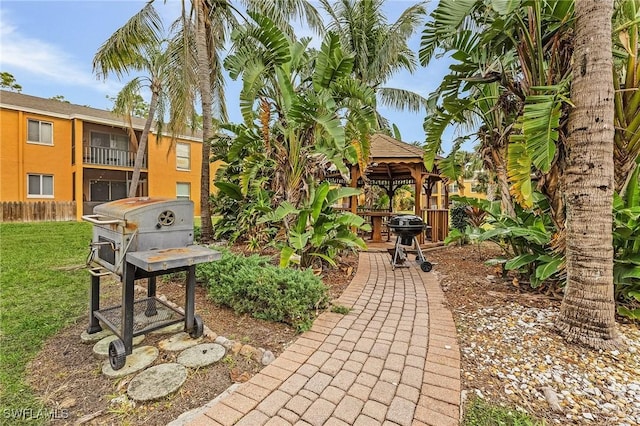 view of patio / terrace featuring a gazebo, a grill, and fence