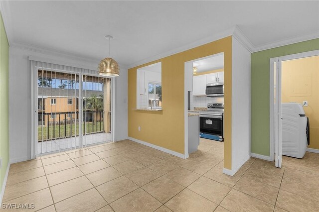 unfurnished dining area with light tile patterned floors, baseboards, and crown molding