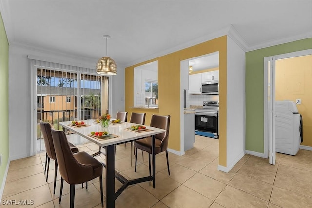 dining space with light tile patterned flooring and crown molding