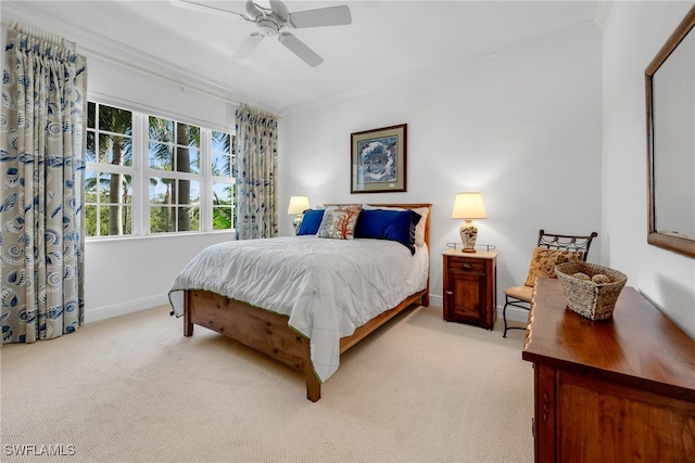 bedroom with baseboards, light carpet, ornamental molding, and a ceiling fan