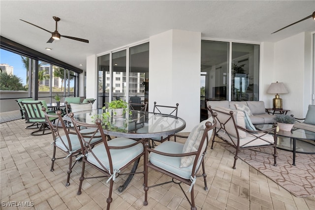 view of patio featuring outdoor dining space, outdoor lounge area, and a ceiling fan