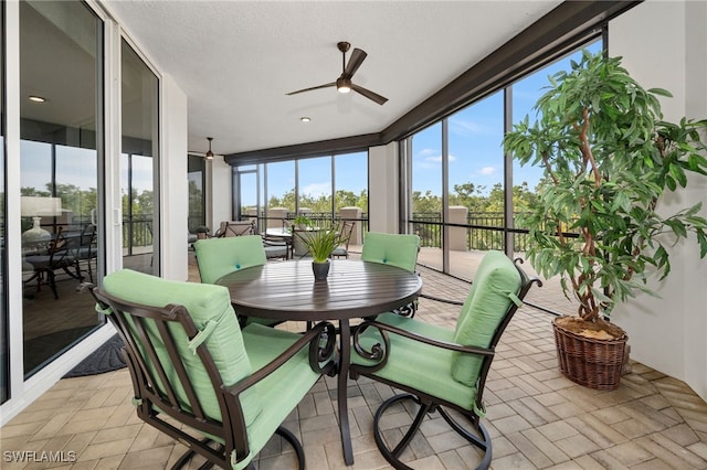 sunroom featuring ceiling fan