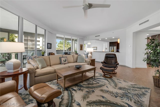 living room with tile patterned flooring, ceiling fan, and crown molding