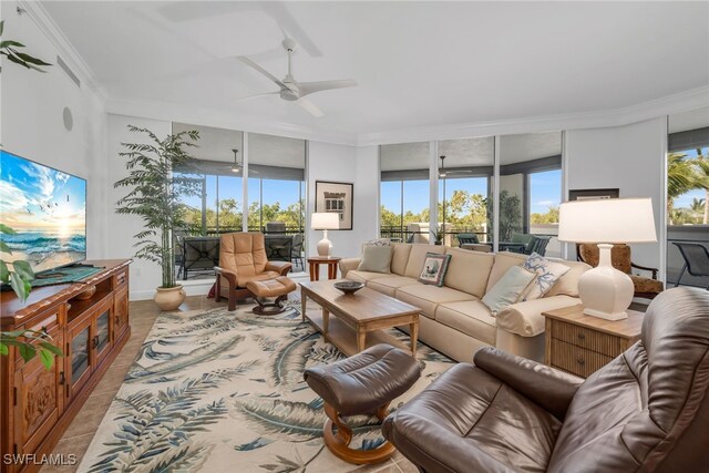 tiled living room with ceiling fan, a healthy amount of sunlight, and crown molding