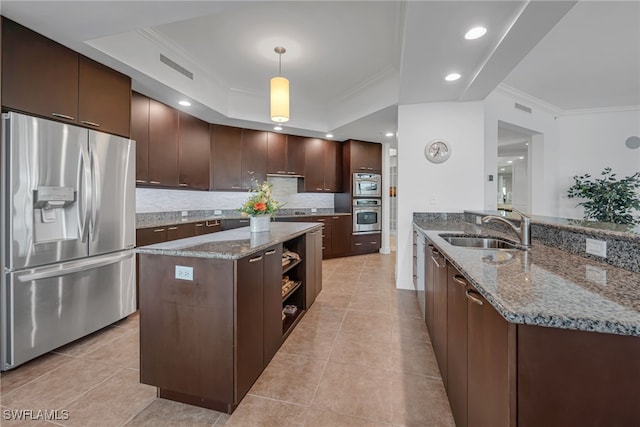 kitchen featuring a raised ceiling, dark brown cabinets, sink, and stainless steel fridge with ice dispenser