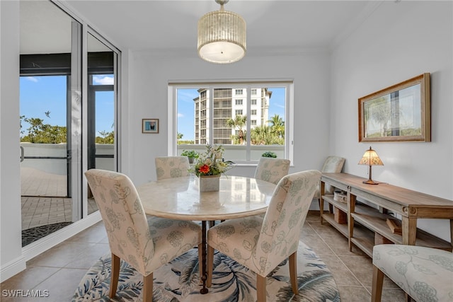 dining area featuring light tile patterned floors and ornamental molding