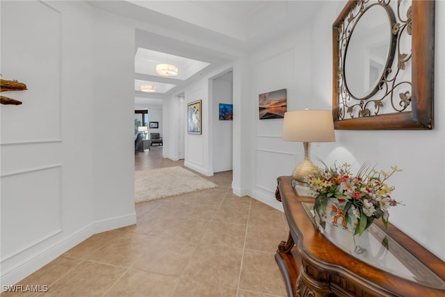 hall with light tile patterned floors and baseboards