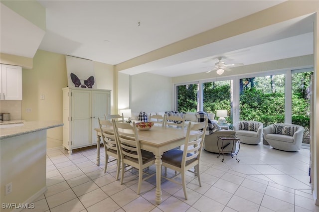 dining space with light tile patterned floors and ceiling fan