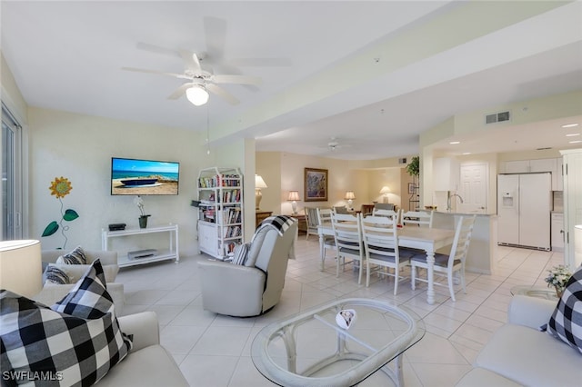 living room featuring ceiling fan and light tile patterned floors