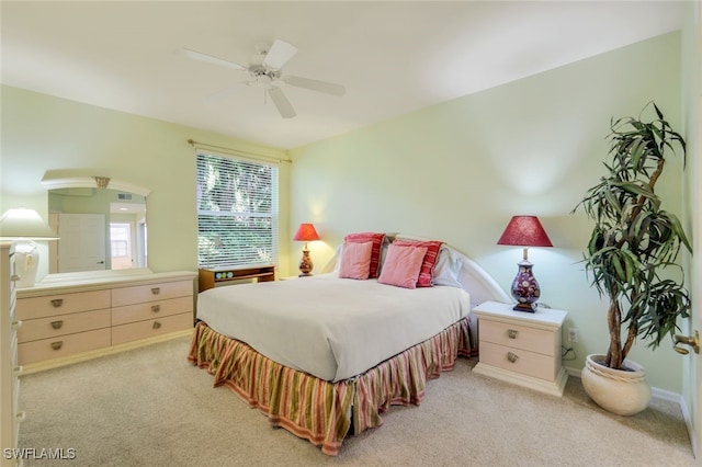 bedroom with light carpet and ceiling fan