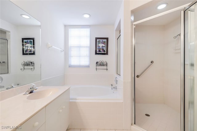 bathroom featuring plus walk in shower and vanity