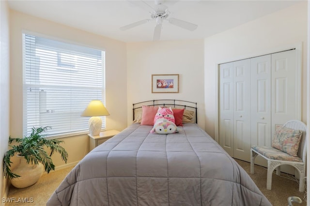 carpeted bedroom featuring a closet and ceiling fan