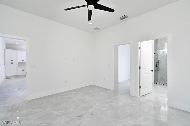 empty room featuring marble finish floor, baseboards, visible vents, and ceiling fan